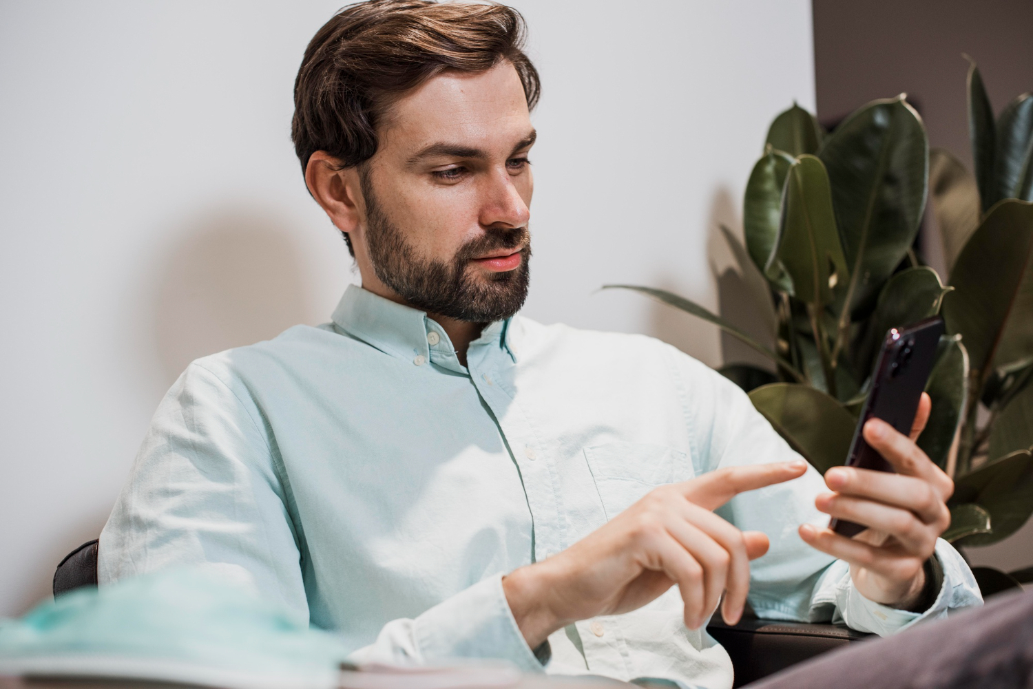 un uomo su una sedia con uno smartphone